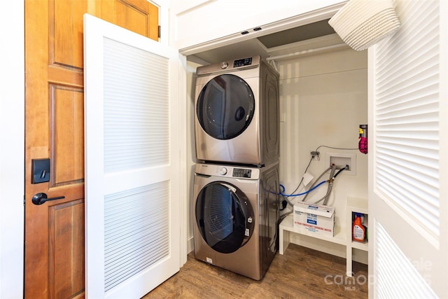 washroom with stacked washer / dryer, laundry area, and dark wood finished floors