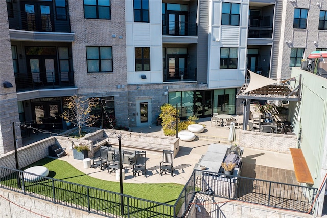 view of property's community with a gazebo, fence, and a patio