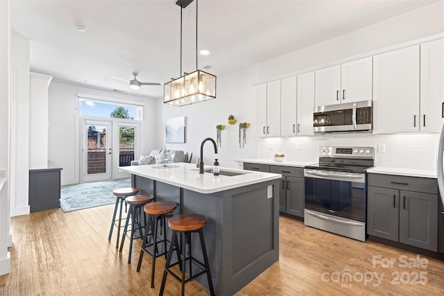 55 S Market St Unit 512, Asheville, NC 28801 - kitchen featuring stainless steel appliances, a sink, gray cabinetry, light wood-style flooring, and recessed lighting