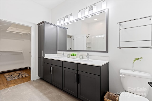 55 S Market St Unit 512, Asheville, NC 28801 - full bath with a stall shower, toilet, a spacious closet, and double vanity