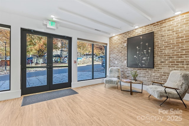 55 S Market St Unit 512, Asheville, NC 28801 - entryway with french doors, wood finished floors, brick wall, and beam ceiling