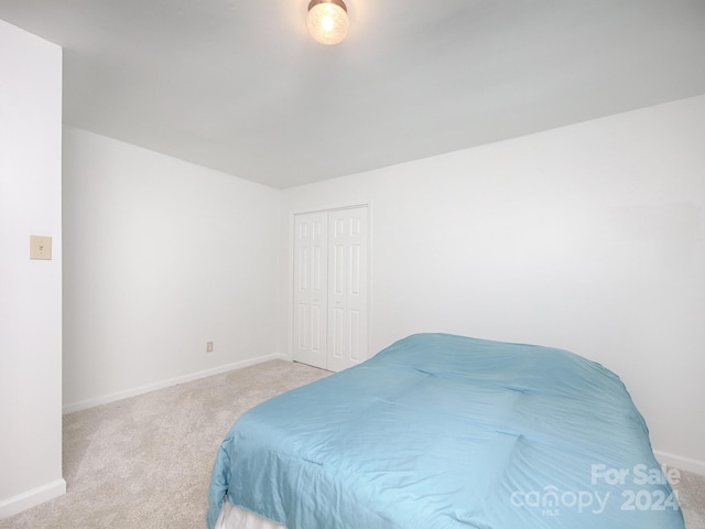 carpeted bedroom with a closet