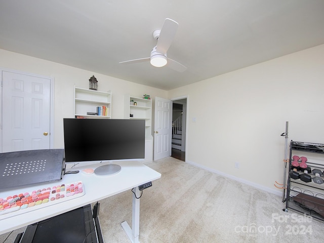 office space with light carpet and ceiling fan