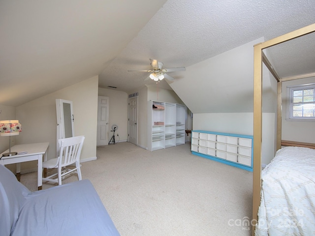 carpeted bedroom featuring ceiling fan, a textured ceiling, and lofted ceiling