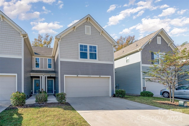 view of front facade featuring a garage and a front lawn