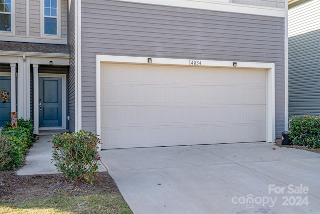 garage featuring concrete driveway
