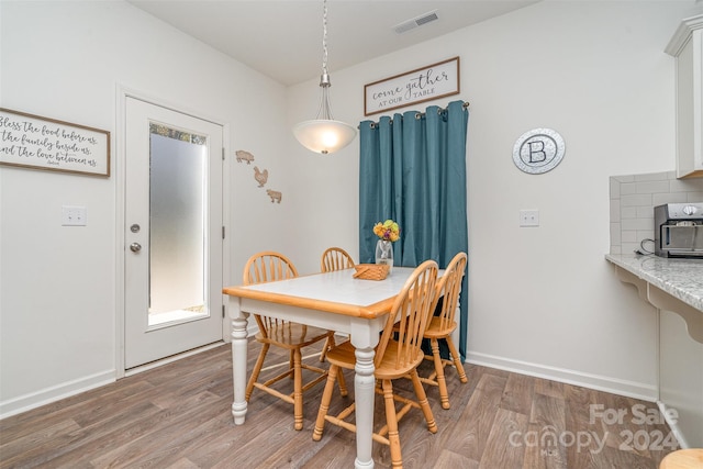 dining area with wood-type flooring