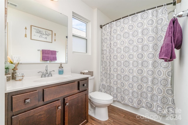 full bathroom with toilet, wood finished floors, vanity, visible vents, and shower / bath combination with curtain