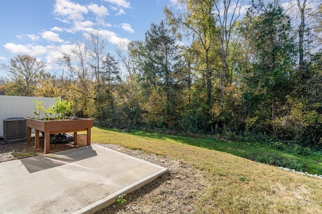 view of yard featuring cooling unit, a patio, and fence