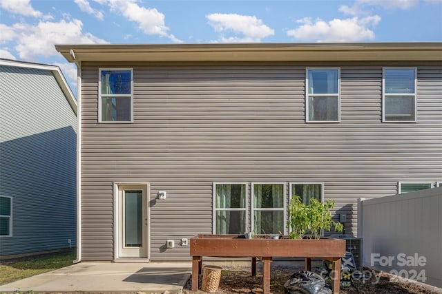 back of house featuring a patio and fence
