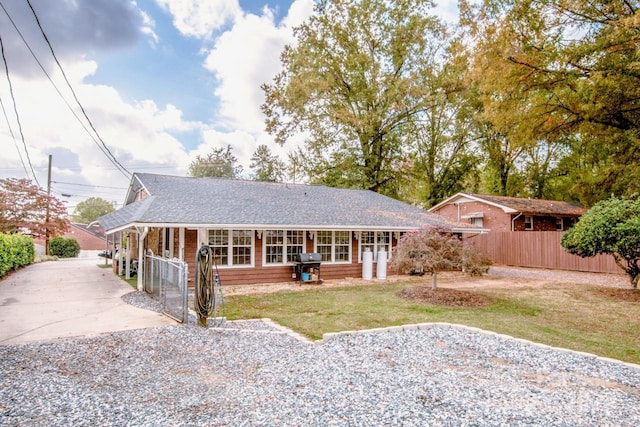 view of front of property with covered porch and a front yard