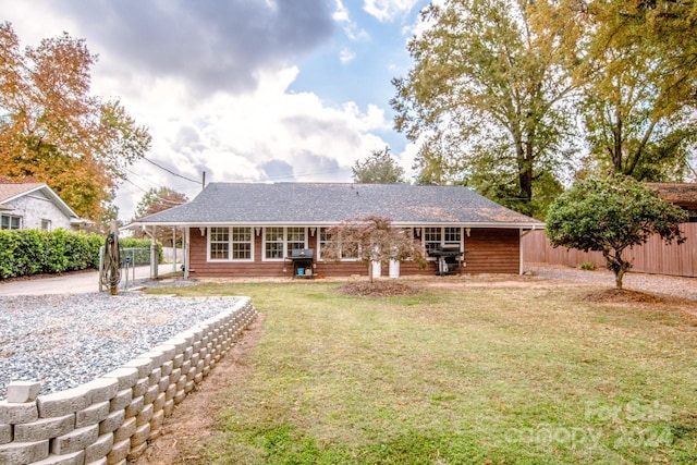 rear view of house with a lawn