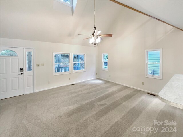 1259 Blacksnake Rd, Stanley, NC 28164 - unfurnished living room with carpet flooring, high vaulted ceiling, a ceiling fan, and baseboards