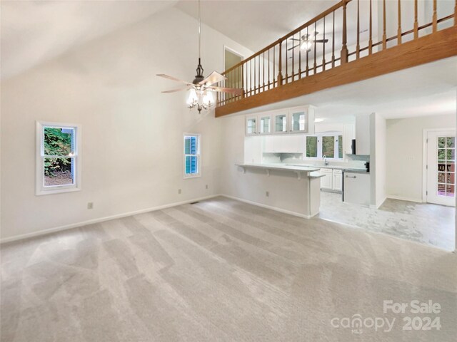 1259 Blacksnake Rd, Stanley, NC 28164 - unfurnished living room with high vaulted ceiling, light colored carpet, baseboards, and a ceiling fan