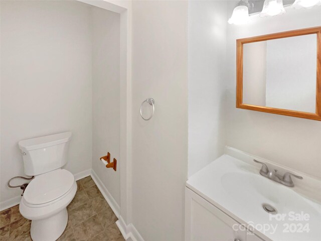 1259 Blacksnake Rd, Stanley, NC 28164 - half bathroom with toilet, vanity, and baseboards