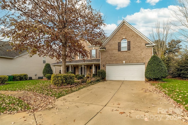 front of property with a garage and a front lawn