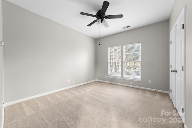 unfurnished bedroom featuring ceiling fan and light colored carpet