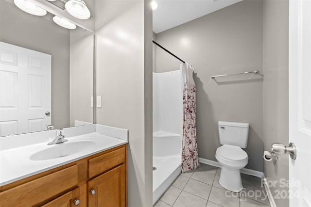 bathroom featuring vanity, toilet, a shower with curtain, and tile patterned flooring