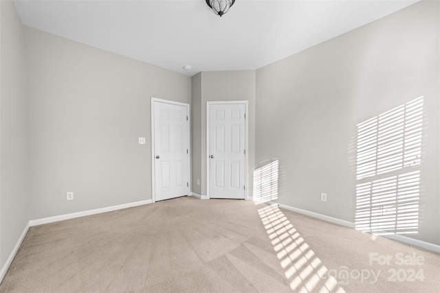 carpeted empty room with a wealth of natural light