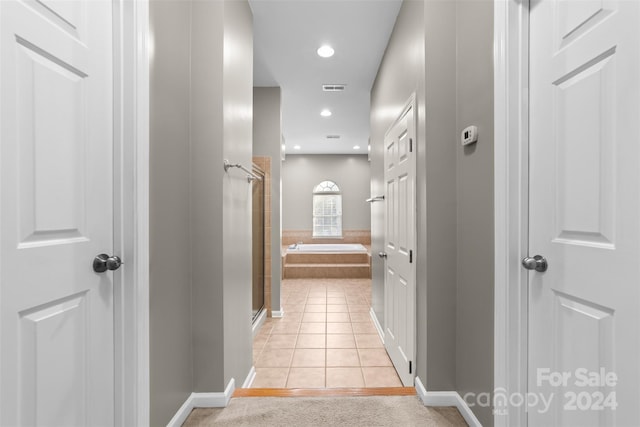 hall featuring light tile patterned flooring