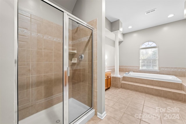 bathroom featuring decorative columns, tile patterned floors, vanity, and separate shower and tub