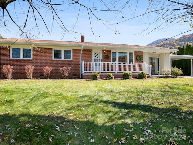 ranch-style house featuring a front lawn and covered porch