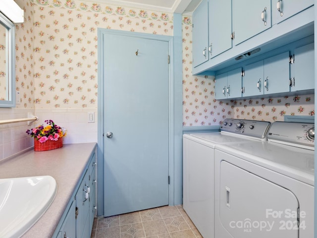 clothes washing area with crown molding, washer and clothes dryer, light tile patterned floors, and sink