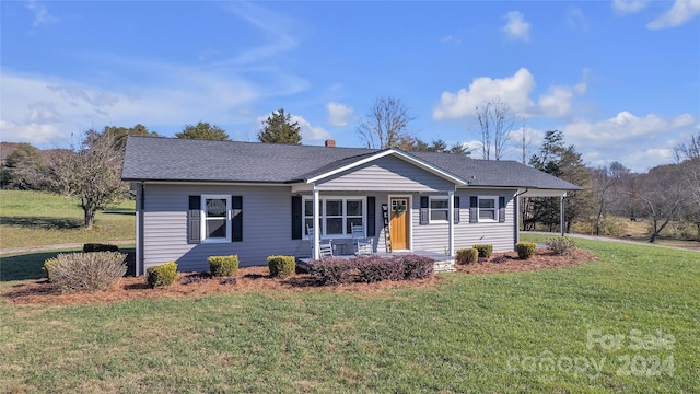 single story home with a porch and a front yard