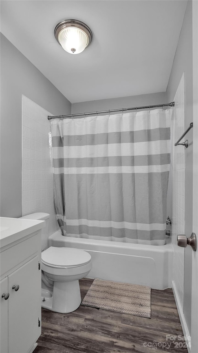 full bathroom featuring toilet, vanity, shower / tub combo, and hardwood / wood-style flooring