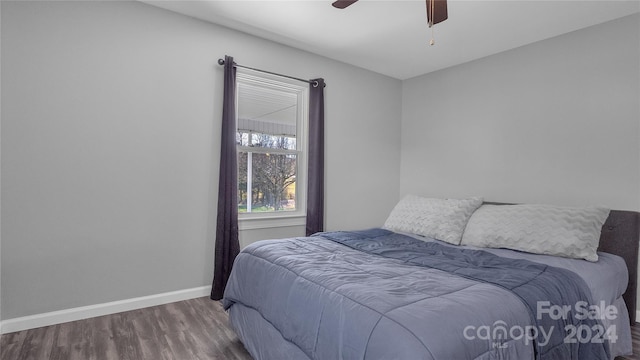 bedroom with ceiling fan and wood-type flooring