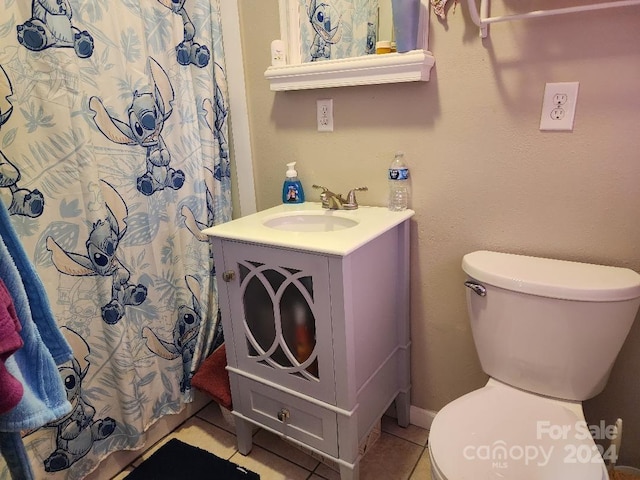 bathroom featuring tile patterned flooring, vanity, toilet, and a shower with shower curtain