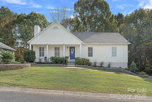 view of front of house with a front yard and covered porch