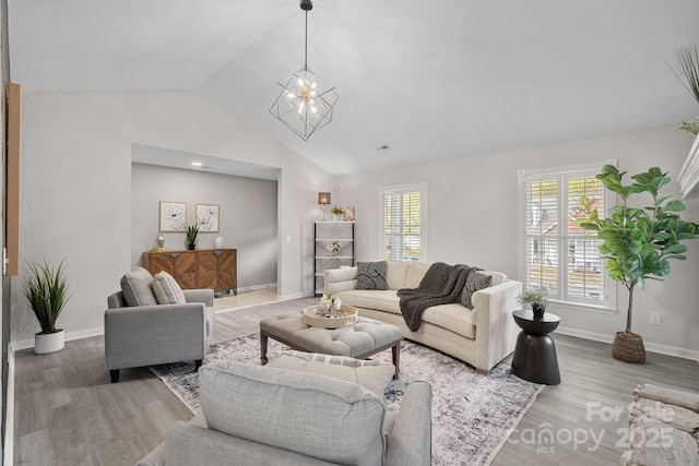 living room with lofted ceiling, wood-type flooring, and a chandelier