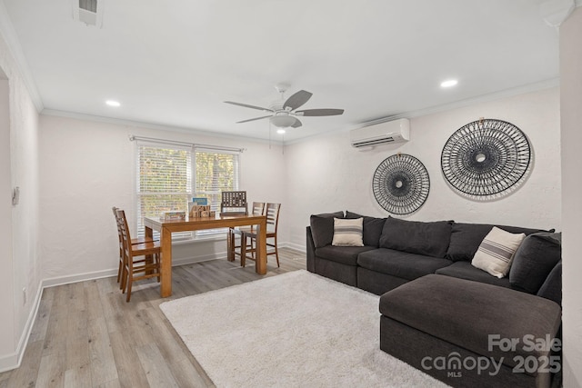 living room featuring crown molding, ceiling fan, a wall mounted AC, and light hardwood / wood-style floors