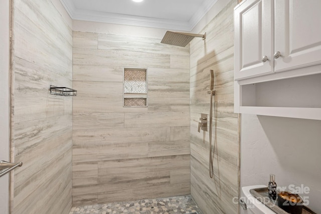 bathroom featuring tiled shower, ornamental molding, and toilet