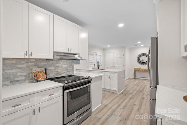 kitchen with crown molding, white cabinetry, stainless steel appliances, light stone countertops, and light wood-type flooring