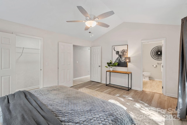 bedroom featuring lofted ceiling, connected bathroom, light hardwood / wood-style flooring, and ceiling fan