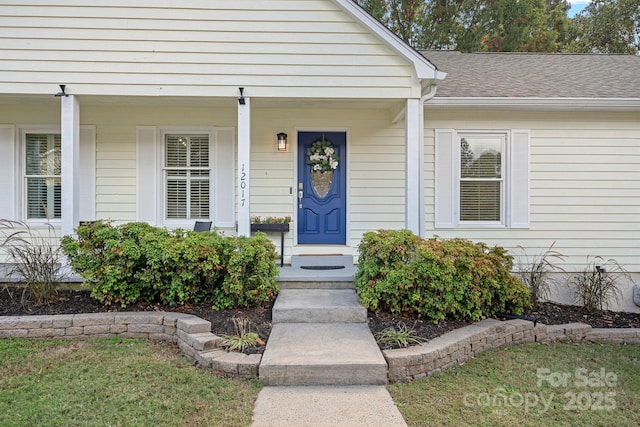 view of exterior entry featuring covered porch