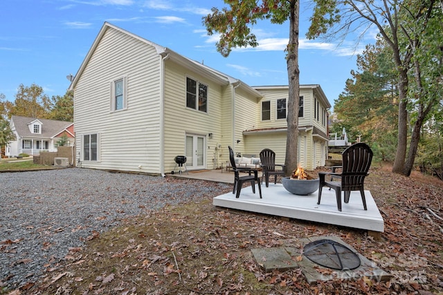 back of house with french doors, an outdoor fire pit, and a patio area