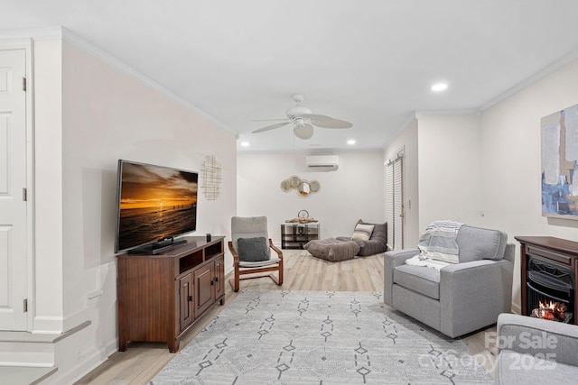 living room with crown molding, light hardwood / wood-style flooring, a wall unit AC, and ceiling fan