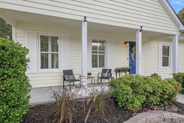 view of exterior entry with a porch