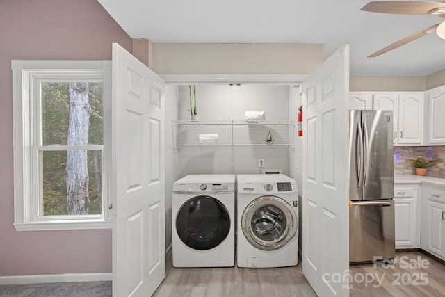 laundry room with ceiling fan, independent washer and dryer, and light hardwood / wood-style floors