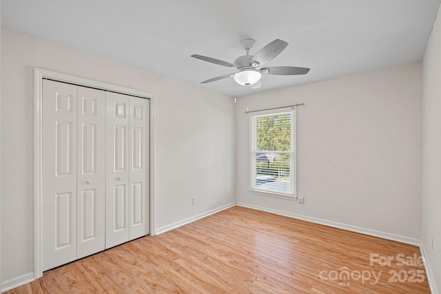 unfurnished bedroom with light hardwood / wood-style floors, ceiling fan, and a closet