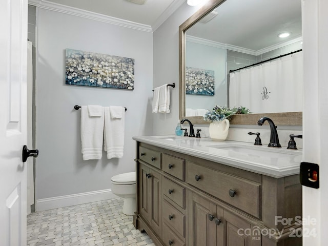 bathroom with vanity, toilet, and ornamental molding