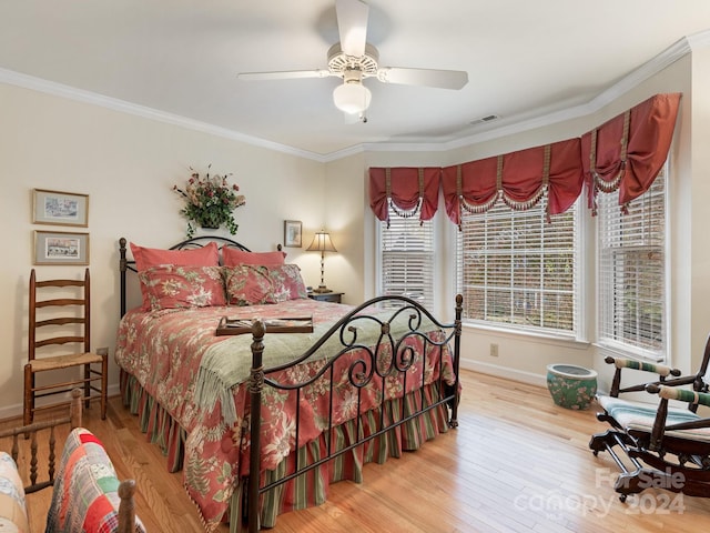 bedroom featuring ornamental molding, light hardwood / wood-style floors, and ceiling fan