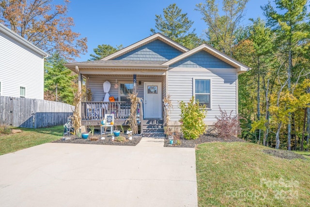 bungalow-style home with a porch and a front yard