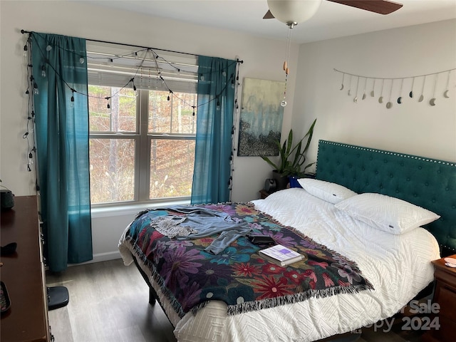 bedroom with wood-type flooring and ceiling fan