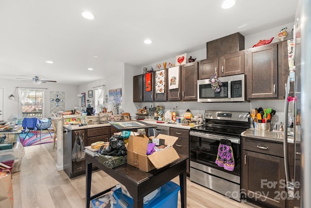 kitchen featuring dark brown cabinets, appliances with stainless steel finishes, light wood-type flooring, and ceiling fan