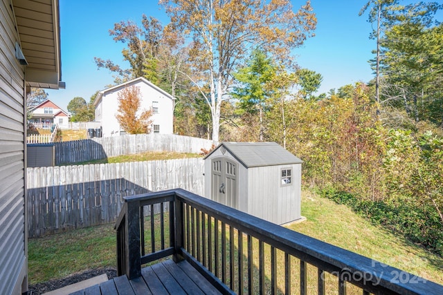 wooden terrace with a yard and a storage shed