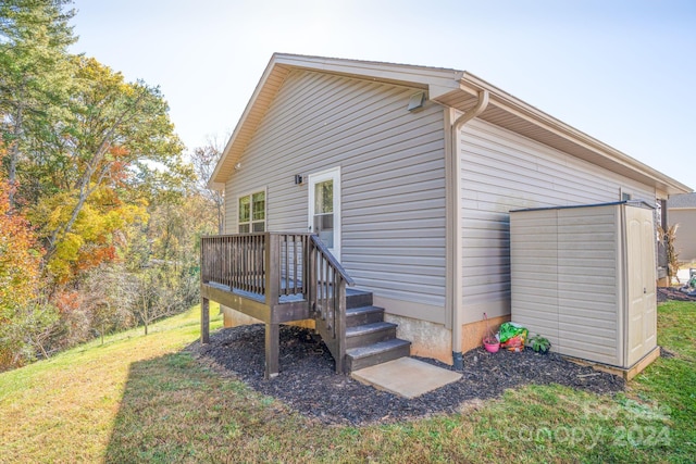 view of home's exterior with a deck and a yard